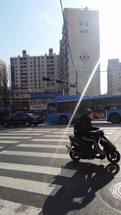 Cross the road towards block 402.