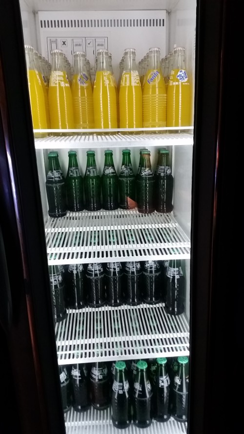 A bottle opener is placed at the left of the fridge to open the bottles.